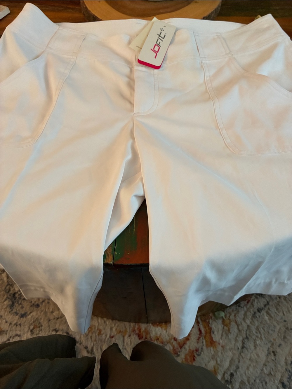 These are Jofit women's white pants featuring a snap closure and a contoured wai